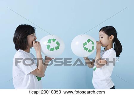 A mother and daughter blowing recycling balloons View Large Photo Image Stock Image - A mother and daughter blowing recycling balloons. Fotosearch
