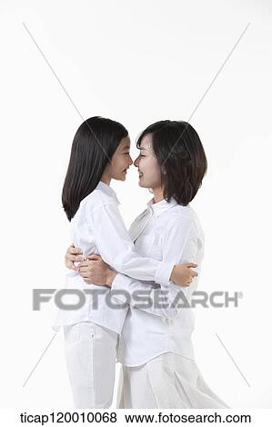 Stock Photo - A mother and daughter facing together. Fotosearch
