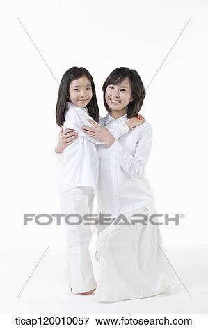 A mother and daughter hugging together View Large Photo Image Stock Photo - A mother and daughter hugging together. Fotosearch