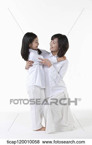 A mother and daughter hugging together View Large Photo Image Stock Photo - A mother and daughter hugging together. Fotosearch