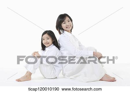Stock Image - A mother and daughter leaning on each other. Fotosearch