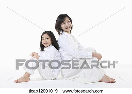 Stock Image - A mother and daughter leaning on each other. Fotosearch