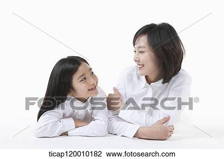 Stock Image - A mother and daughter looking at each other. Fotosearch