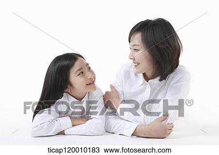 Stock Image - A mother and daughter looking at each other. Fotosearch
