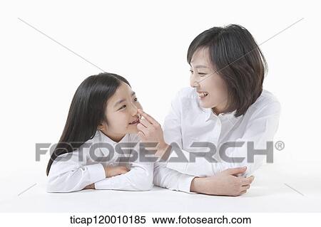 Stock Photography - A mother and daughter looking at each other. Fotosearch
