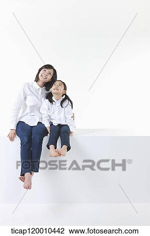 A mother and daughter looking at the sky View Large Photo Image Stock Image - A mother and daughter looking at the sky . Fotosearch