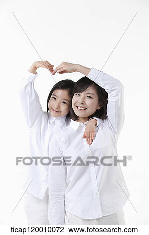A mother and daughter making heart over the head View Large Photo Image Stock Image - A mother and daughter making heart over the head. Fotosearch