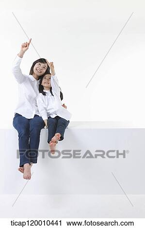 A mother and daughter pointing to the sky View Large Photo Image Stock Image - A mother and daughter pointing to the sky . Fotosearch