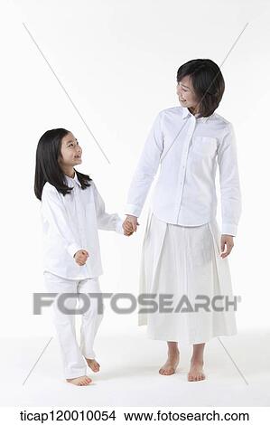 Picture - A mother and daughter smiling at each other. Fotosearch