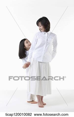 Stock Image - A mother and daughter smiling at each other. Fotosearch