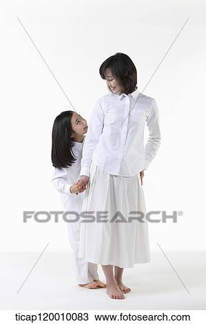 Stock Image - A mother and daughter smiling at each other. Fotosearch