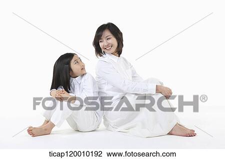A mother and daughter smiling at each other View Large Photo Image Stock Image - A mother and daughter smiling at each other. Fotosearch