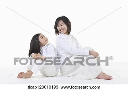 A mother and daughter smiling at each other View Large Photo Image Stock Image - A mother and daughter smiling at each other. Fotosearch