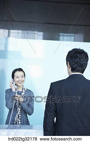 A receptionist connecting a call View Large Photo Image Stock Photo - A receptionist connecting a call. Fotosearch