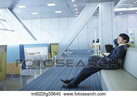 Stock Photography - A smiling businessman with the tablet PC. Fotosearch