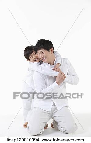 A son hugging his father from the back View Large Photo Image Picture - A son hugging his father from the back. Fotosearch