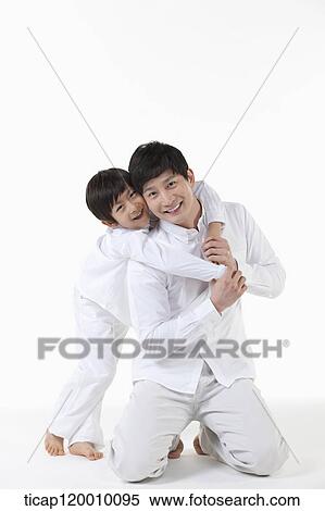 A son hugging his father from the back View Large Photo Image Stock Photography - A son hugging his father from the back. Fotosearch