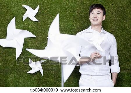 A standing man and a white pinwheel View Large Photo Image Stock Photo - A standing man and a white pinwheel. Fotosearch