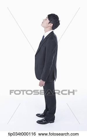 Stock Photograph - A standing man with his eyes closed. Fotosearch