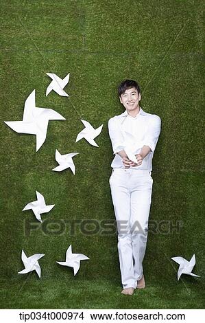 Picture - A standing man with white pinwheels. Fotosearch
