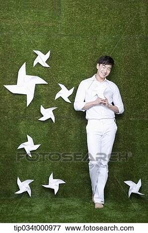 A standing man with white pinwheels View Large Photo Image Stock Photo - A standing man with white pinwheels. Fotosearch