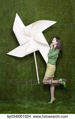 A standing woman with a big white pinwheel View Large Photo Image Picture - A standing woman with a big white pinwheel. Fotosearch