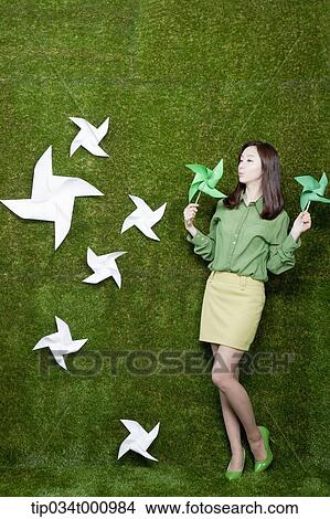 A standing woman with green and white pinwheels View Large Photo Image Picture - A standing woman with green and white pinwheels. Fotosearch