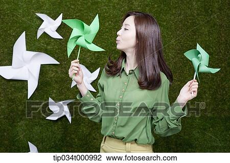A standing woman with green and white pinwheels View Large Photo Image Stock Image - A standing woman with green and white pinwheels. Fotosearch