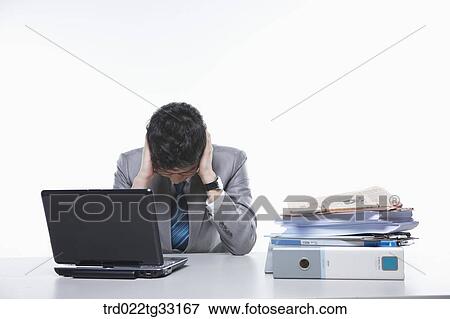 A stressful businessman with the work burden View Large Photo Image Stock Photo - A stressful businessman with the work burden. Fotosearch