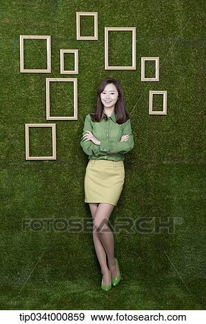 A woman and wooden frames on the green wall View Large Photo Image Stock Photo - A woman and wooden frames on the green wall. Fotosearch