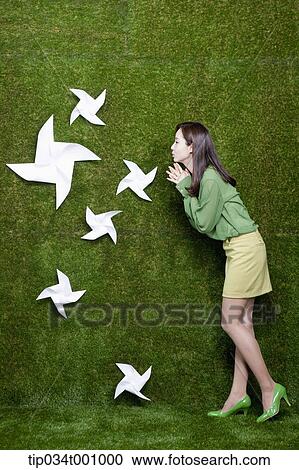 A woman blowing the white pinwheels View Large Photo Image Stock Image - A woman blowing the white pinwheels. Fotosearch
