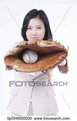A woman catching a baseball with a glove View Large Photo Image Stock Photo - A woman catching a baseball with a glove. Fotosearch