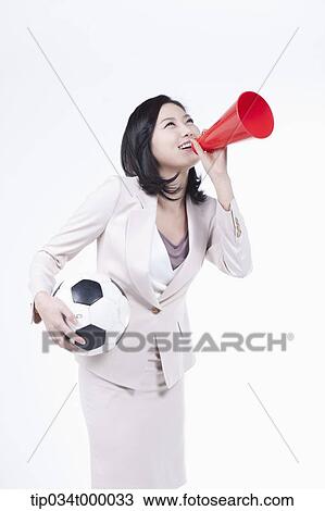 A woman cheering with soccer ball and loud speaker View Large Photo Image Stock Image - A woman cheering with soccer ball and loud speaker. Fotosearch