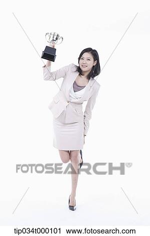 A woman holding a trophy View Large Photo Image Stock Image - A woman holding a trophy. Fotosearch