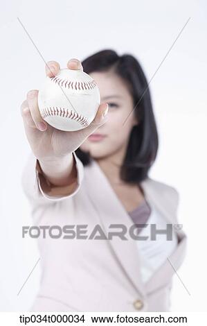Picture - A woman holding the baseball. Fotosearch