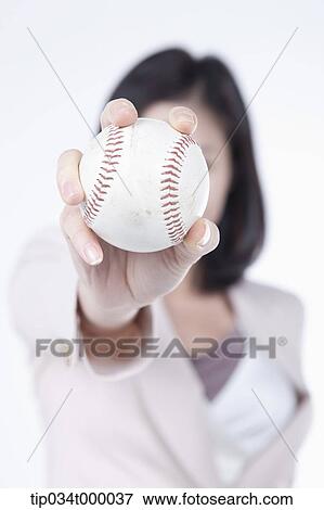 Stock Photo - A woman holding the baseball. Fotosearch