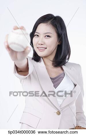 Stock Photograph - A woman holding the baseball. Fotosearch