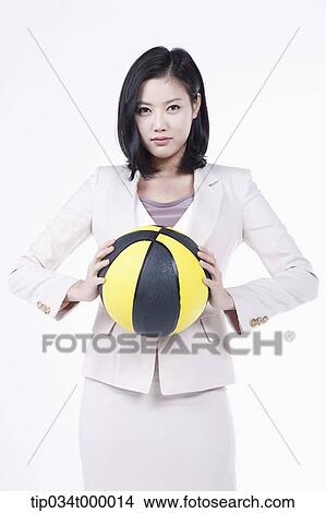 Picture - A woman holding the basketball. Fotosearch