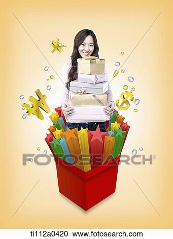 A woman holding the gift boxes in the star box View Large Photo Image Stock Image - A woman holding the gift boxes in the star box. Fotosearch