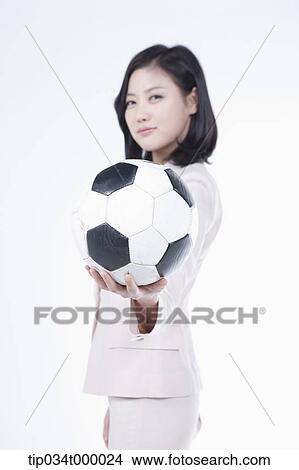 Picture - A woman holding the soccer ball. Fotosearch
