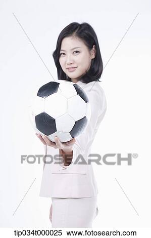 Stock Photography - A woman holding the soccer ball. Fotosearch