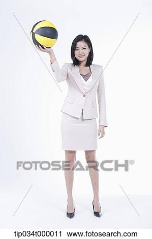A woman holding up the basketball View Large Photo Image Stock Image - A woman holding up the basketball. Fotosearch