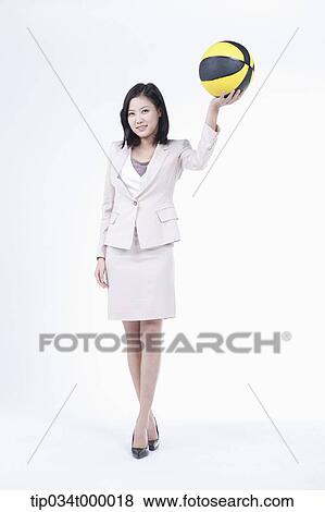 A woman holding up the basketball View Large Photo Image Stock Photo - A woman holding up the basketball. Fotosearch
