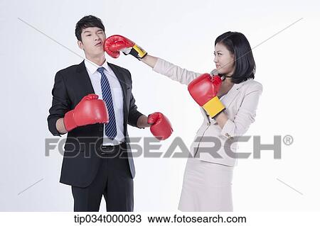 Stock Image - A woman punching on a man . Fotosearch