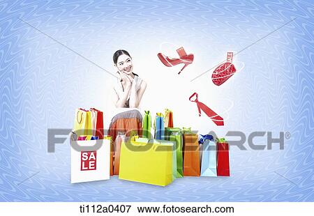 A woman sitting around the shopping bags View Large Photo Image Stock Photo - A woman sitting around the shopping bags. Fotosearch