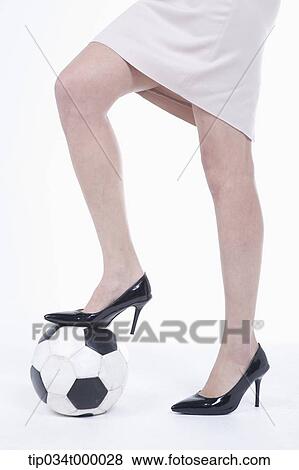 Stock Photo - A woman stepping on the soccer ball. Fotosearch