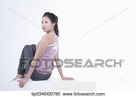 Stock Image - A woman stretching her body. Fotosearch