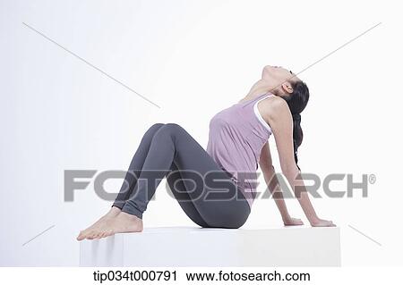 Stock Image - A woman stretching her body. Fotosearch