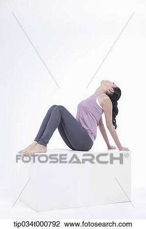 Stock Image - A woman stretching her body. Fotosearch