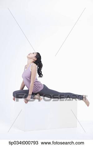 Stock Image - A woman stretching her body. Fotosearch
